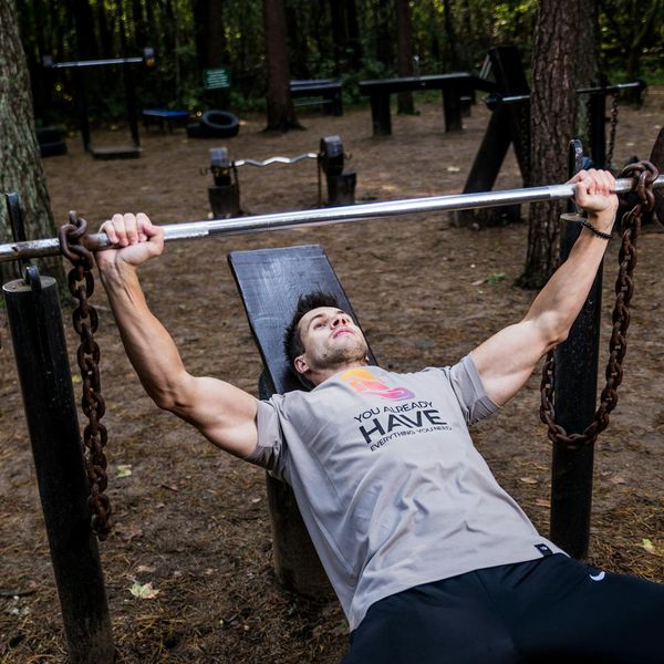 Focused man lifting weights with proper form and concentration.